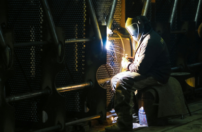 An operator doing welds on steel